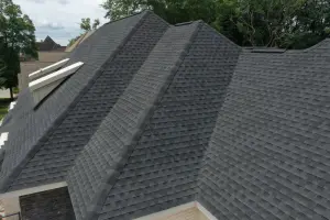 A large dark gray shingle roof with multiple hips and valleys